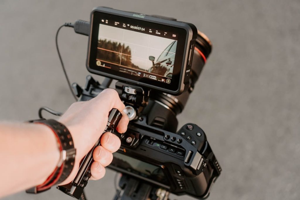 A professional camera rig with an Atomos Shinobi monitor and SmallRig handle set up for mobile video production as part of a TikTok Creative Strategy.