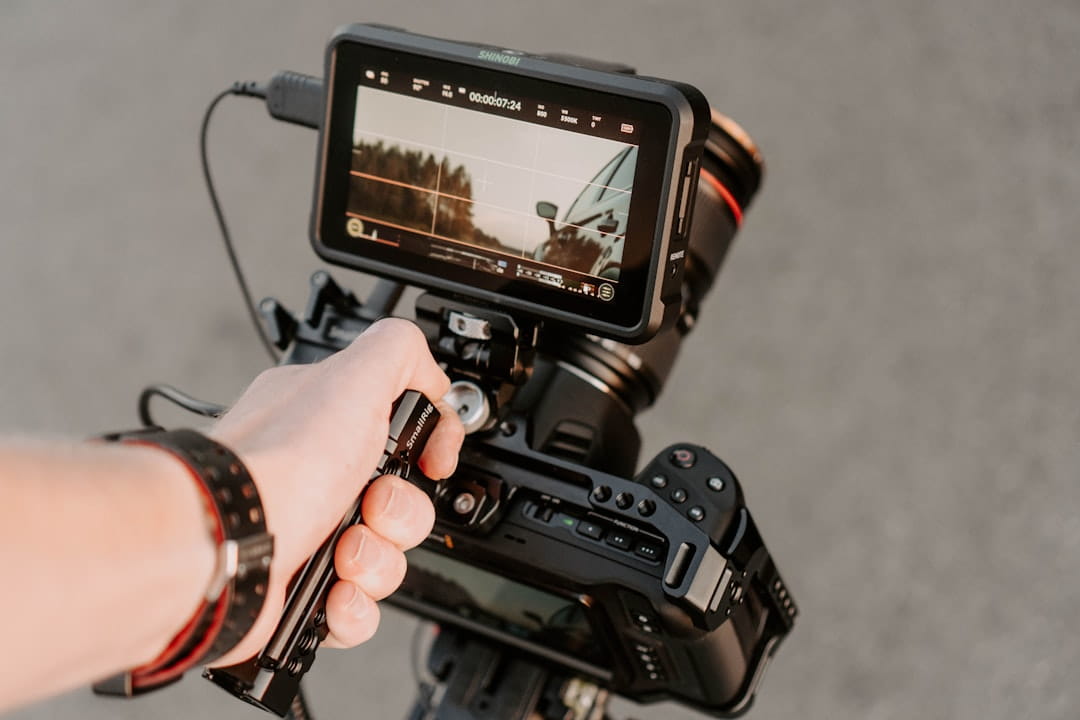 A professional camera rig with an Atomos Shinobi monitor and SmallRig handle set up for mobile video production as part of a TikTok Creative Strategy.