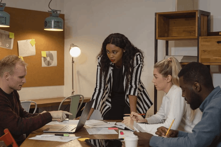 Diverse team discussing the B2B buyer journey around a wooden table in a modern office.