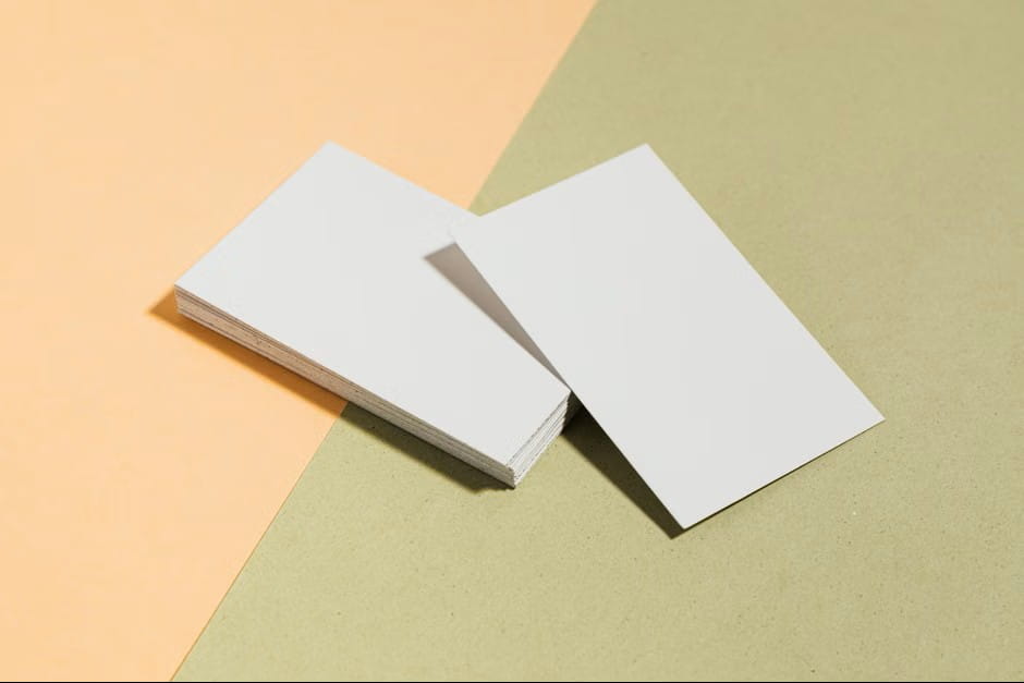 Minimal mockup featuring blank white stationery on a peach and sage background for clean business card ideas.