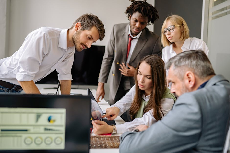 Team reviewing business management dashboards together in a modern office