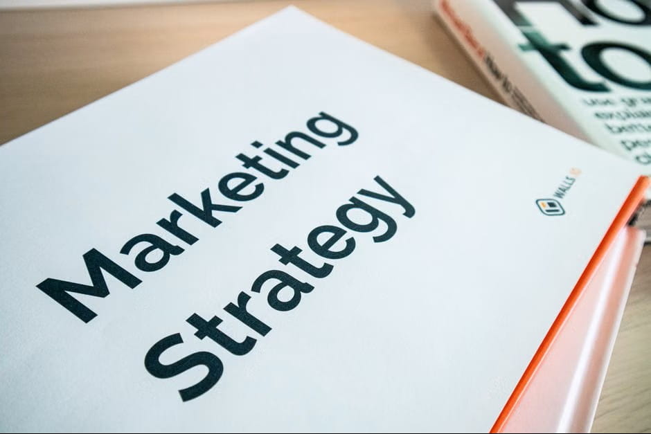 business books on a desk featuring marketing strategy inspiration for a go to market strategy template.