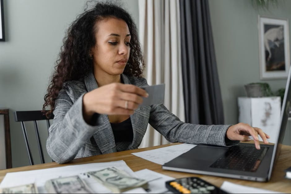 woman managing cash and card payments while researching great banks for small business.