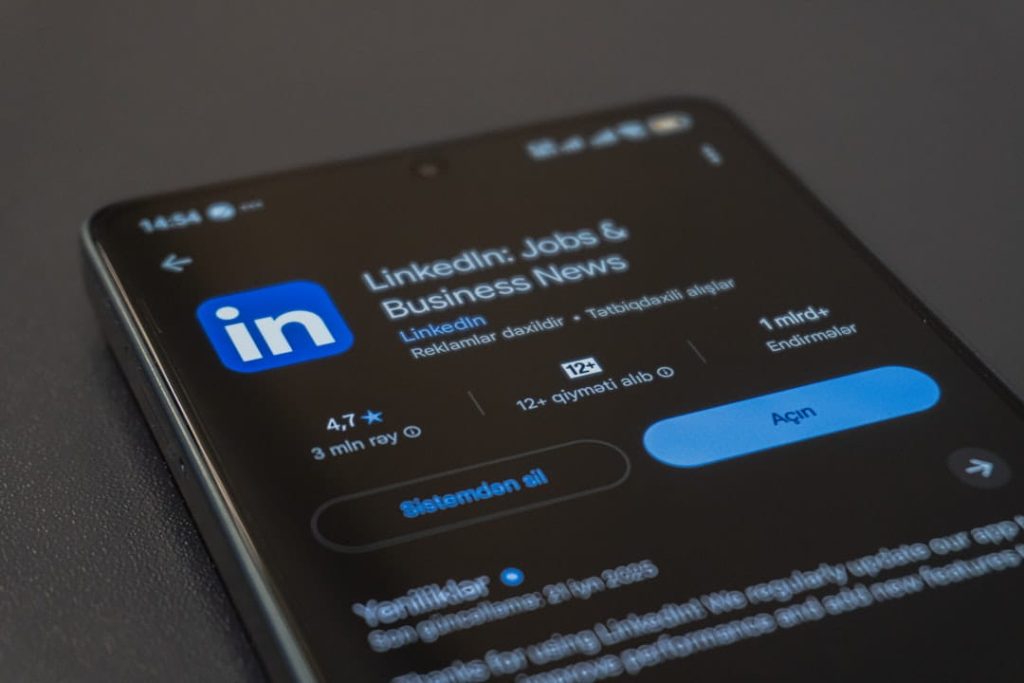 A smartphone screen displaying the LinkedIn app's listing in an app store, a great tool when learning how to follow up after a networking event. The screen shows the app's title, logo, 4.7-star rating from 3 million reviews, over 1 billion downloads, and options to uninstall or open the app. The dark mode interface highlights the app's details and update information.