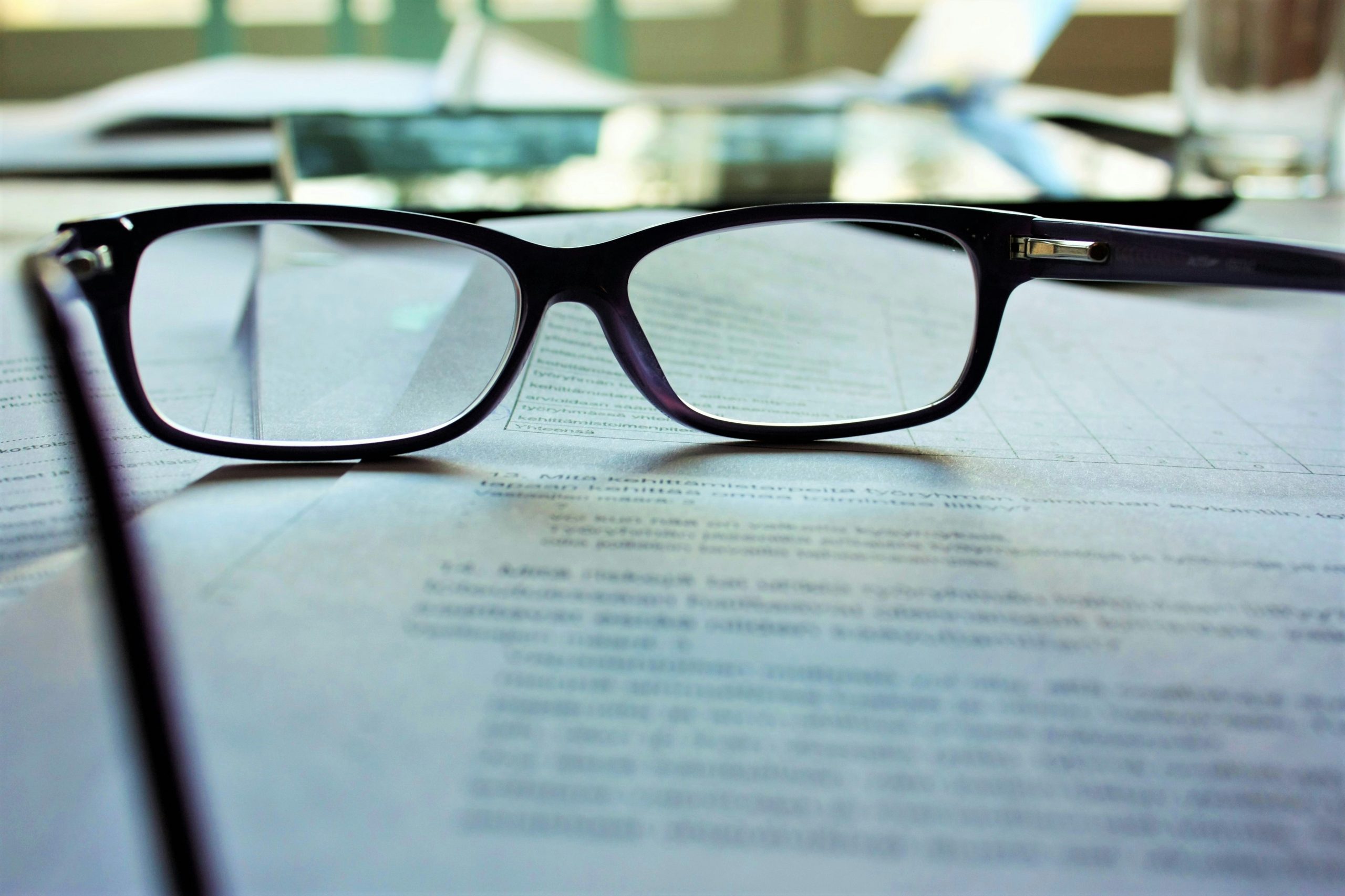 a pair of glasses on a piece of paper explaining how to price a business for sale