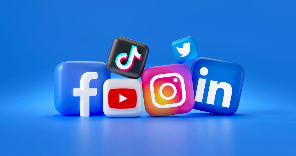 3D-rendered icons of six popular social media platforms—Facebook, YouTube, TikTok, Instagram, Twitter (bird logo), and LinkedIn—arranged dynamically on a vibrant blue background. Each icon is a glossy, rounded square with distinct brand colors and logos, slightly tilted and overlapping, creating a modern and engaging composition, highlighting the best time to post on social media for maximum engagement.