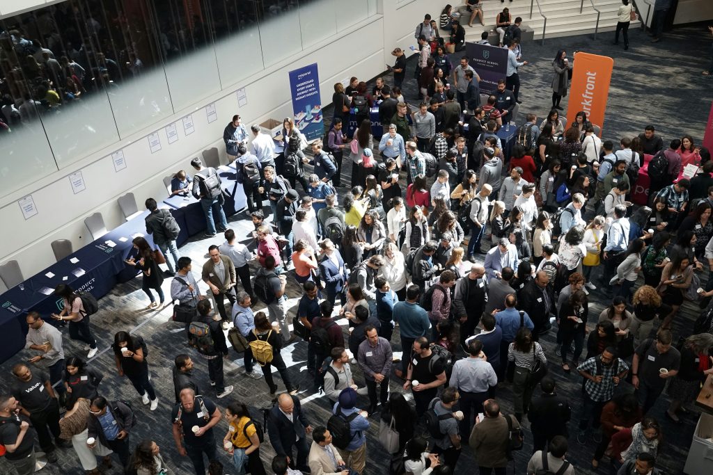 A professional networking events Las Vegas with a large crowd of attendees engaged in conversations and activities. The event is well-lit, with natural light streaming in from the top left, and the atmosphere is lively and focused on professional development and industry connections.