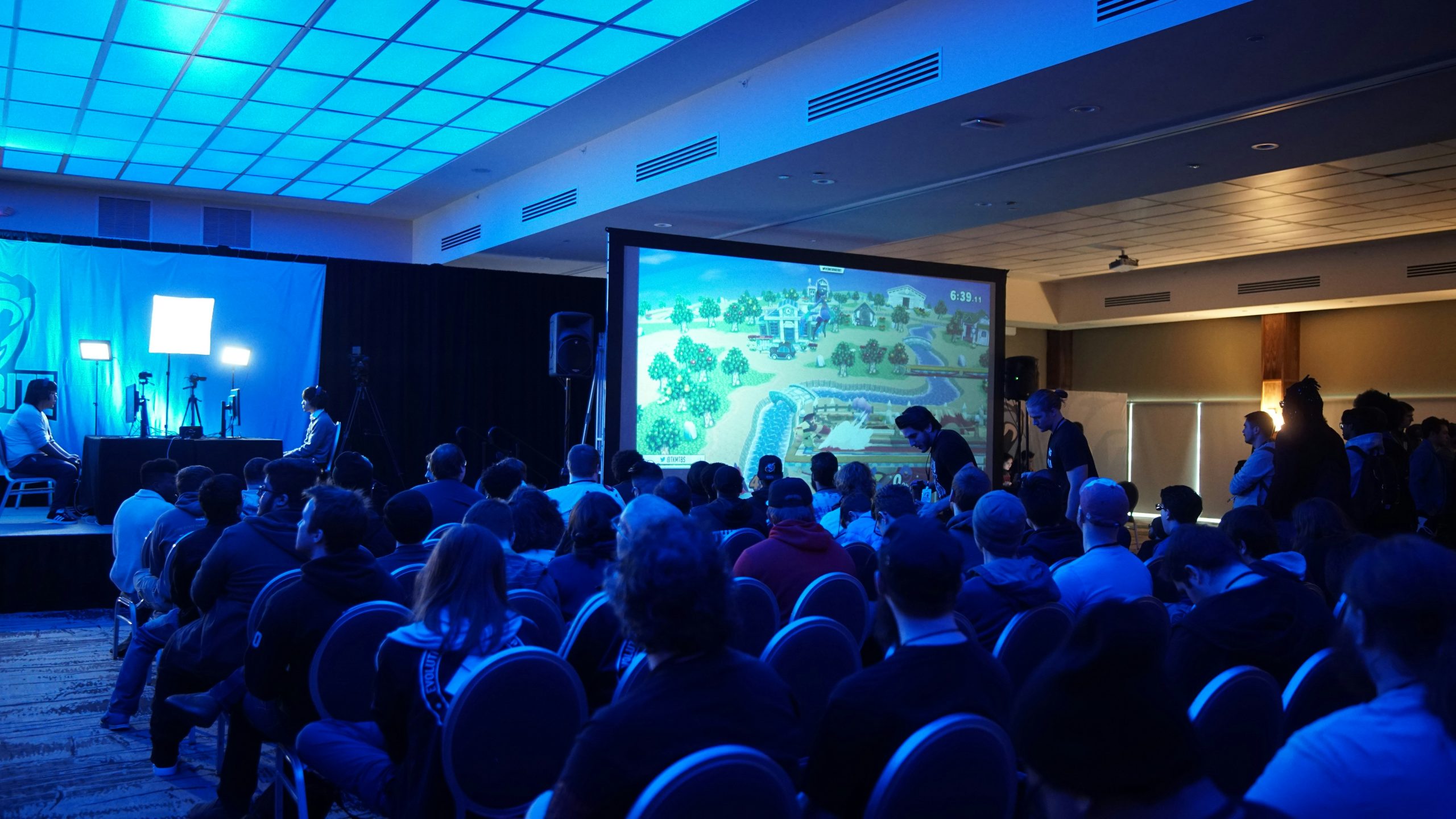 a group of people at a trade shows with a screen