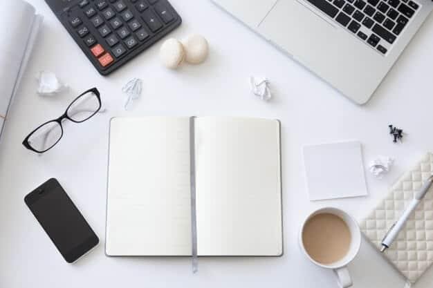top-view-of-a-working-desk-with-open-blank-notebook_1163-2581